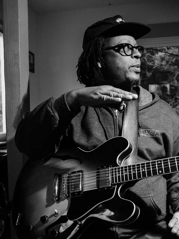 Musician Jeff Parker in the studio with his guitar.